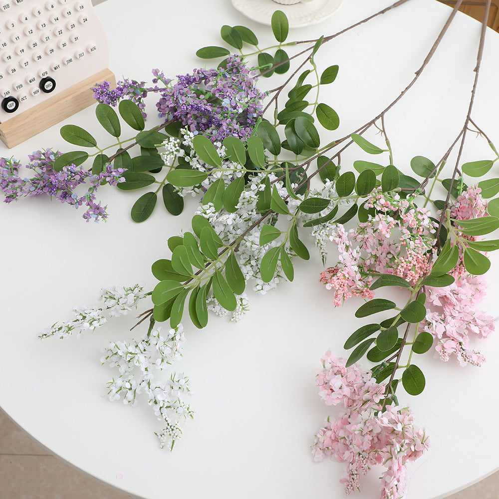 Artificial flower branch with vibrant purple flowers