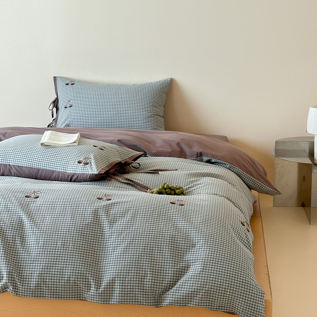 Reversible cotton bedding set with fine check pattern, cherry embroidery, and decorative tie ribbons