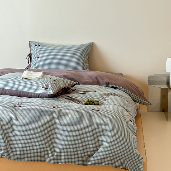 Reversible cotton bedding set with fine check pattern, cherry embroidery, and decorative tie ribbons