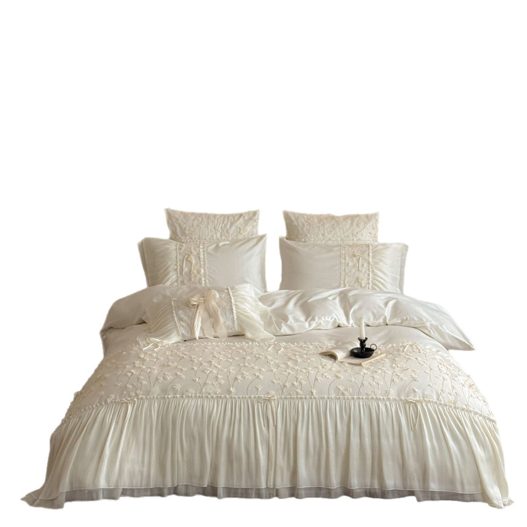Embroidered bedding set with ruffles and three-dimensional flower appliqués