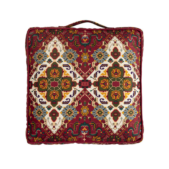 Square decorative cushion with oriental medallion print, piping and carrying handle