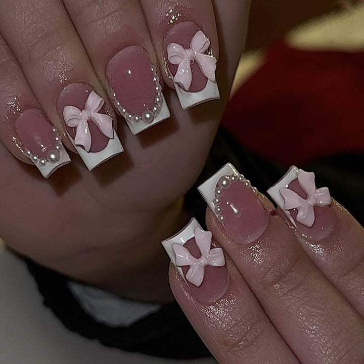 Artificial nails with elegant bows and pearl embellishments Kalsten