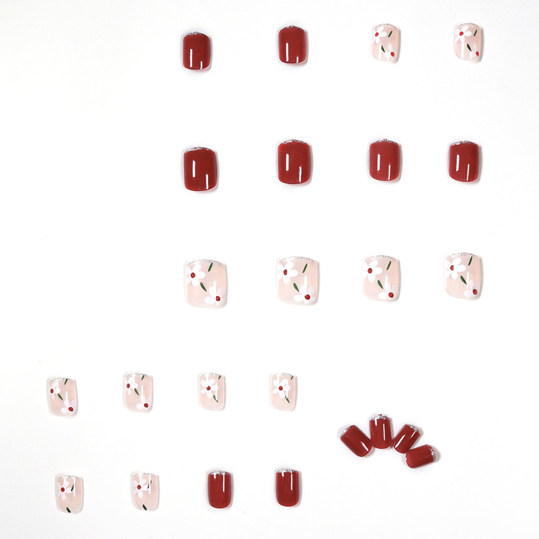 Artful nail art with floral motifs and glitter accents Kalsten