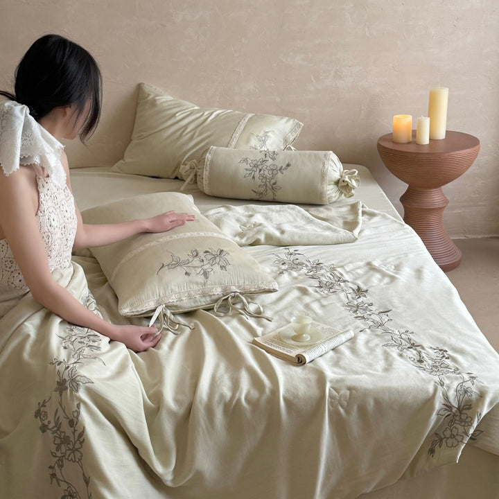 Elegant bedding set made of cotton satin with floral embroidered border and decorative roll cushion Kalsten