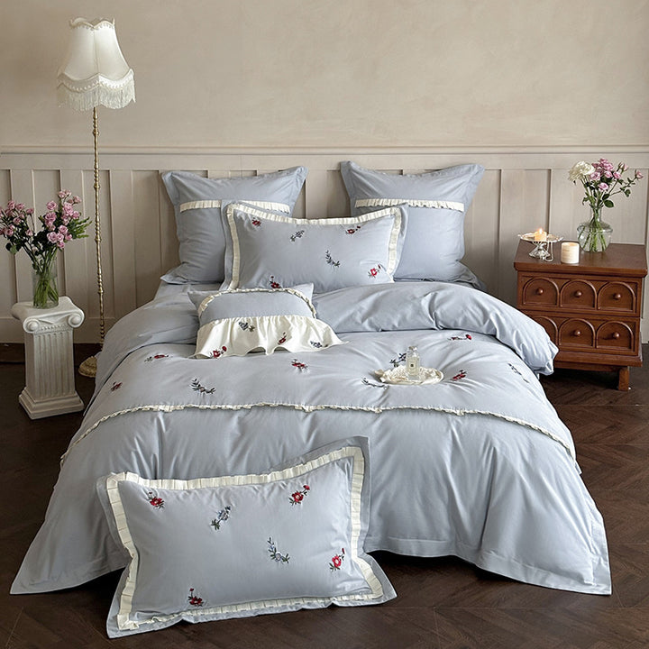 Duvet cover set made of premium cotton satin with subtly embroidered wildflower motif and ruffle edge
