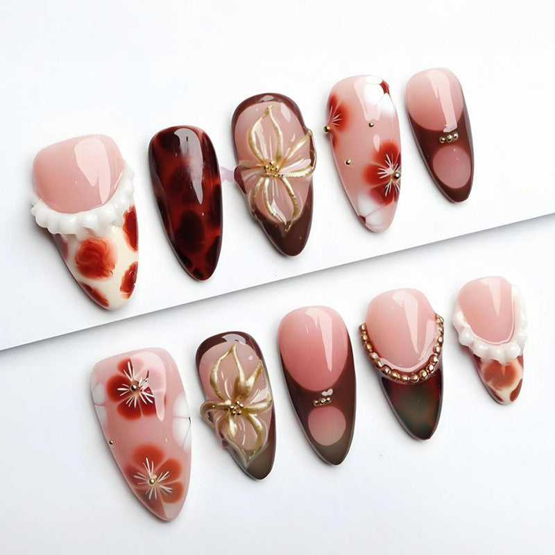 Artificial nail set with luxurious floral designs and glitter accents Kalsten