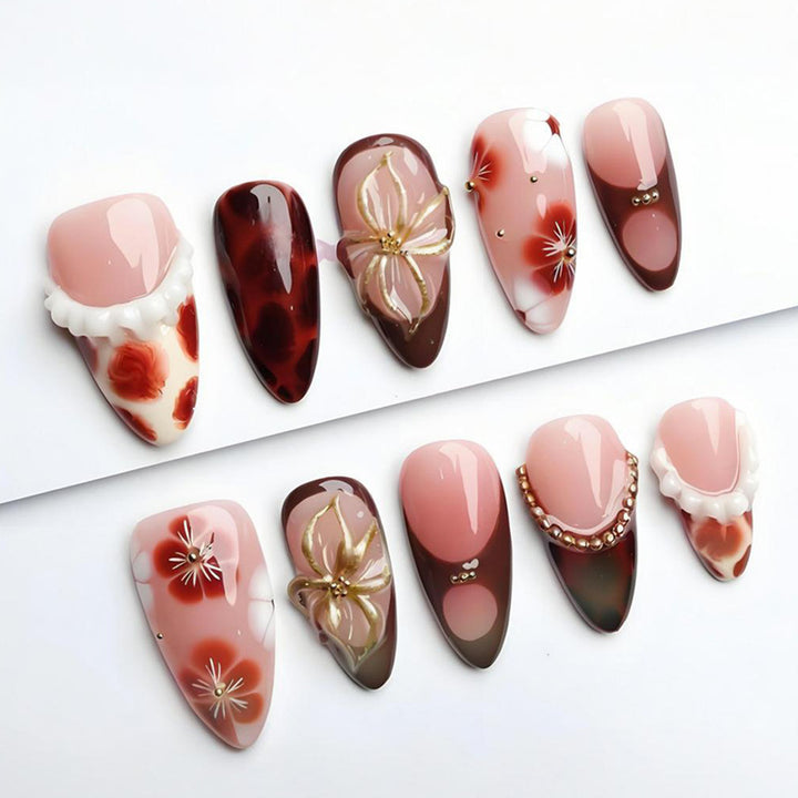 Artificial nail set with luxurious floral designs and glitter accents Kalsten