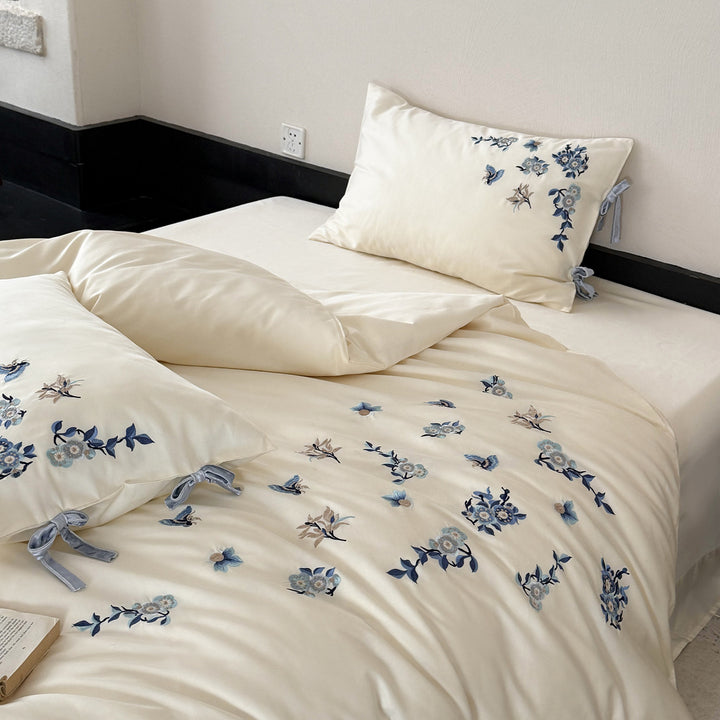 Embroidered satin bedding set with delicate floral details