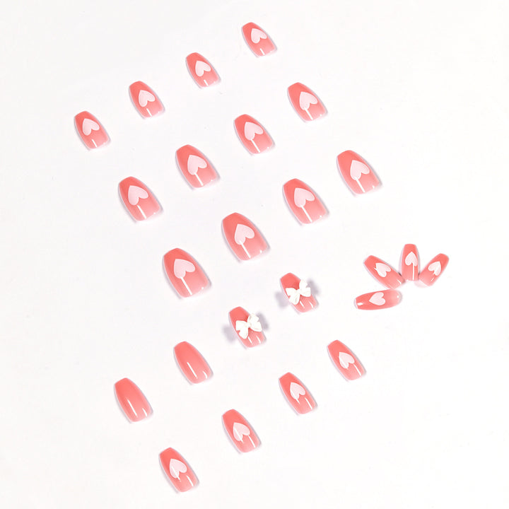 Artistic acrylic nails with heart and bow motifs Kalsten