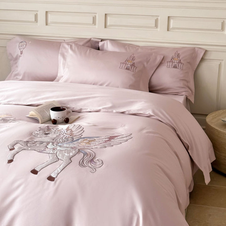 Luxurious satin bedding set with embroidered unicorn motif and fairy tale castle application