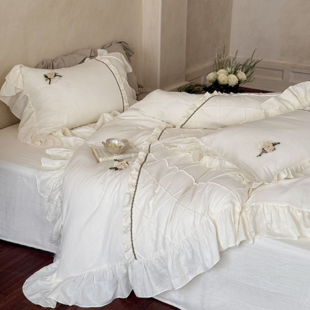 Country house style bedding set with quilted center piece, ruffle and rose appliqué