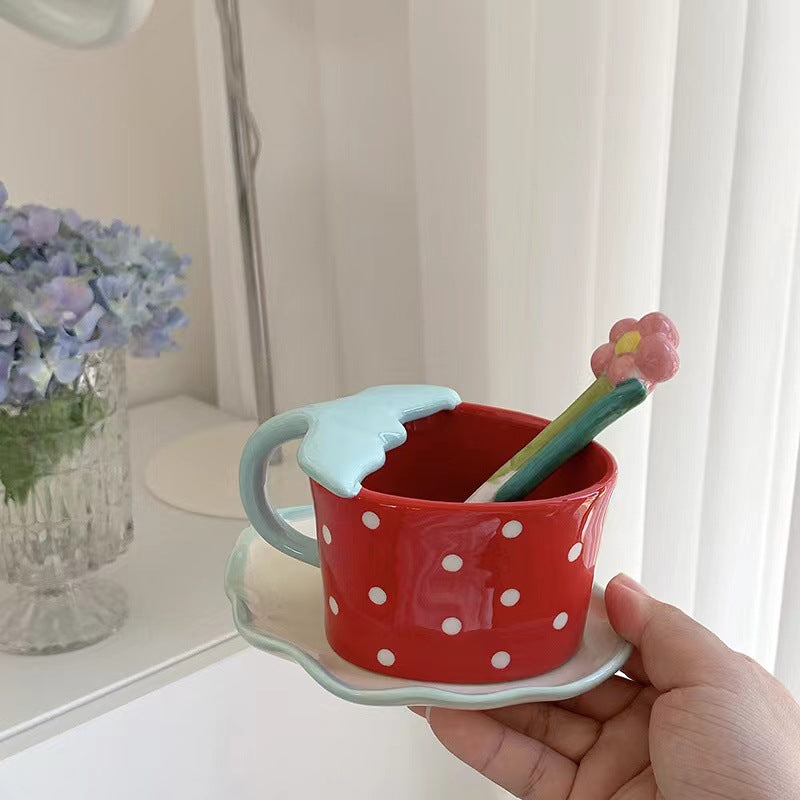 Playful ceramic mug with shaped leaf handle, saucer, and tulip spoon