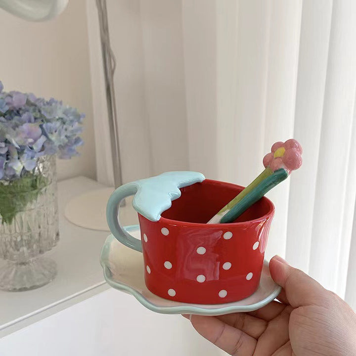 Playful ceramic mug with shaped leaf handle, saucer, and tulip spoon