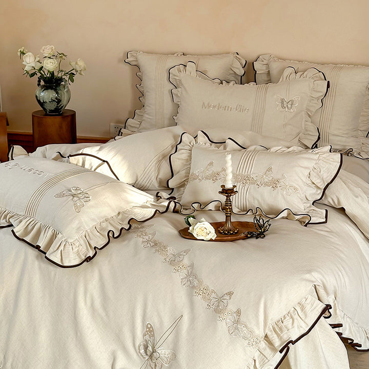 Luxurious bedding set made of cotton satin with embroidered butterfly motif, frill and decorative piping