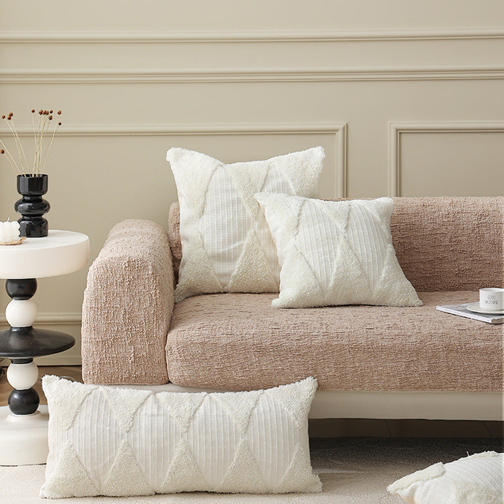 Square decorative pillow with tufted triangle structure and bouclé surface