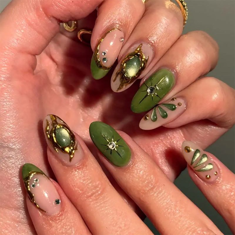Artistic nail extensions with elegant gold and green shimmer Kalsten