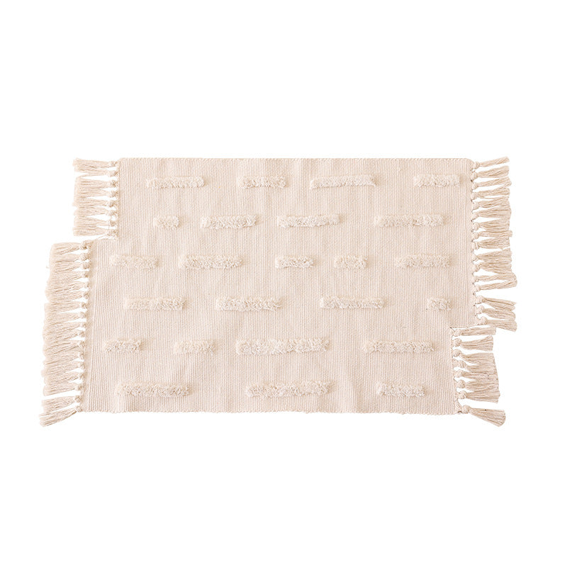 handwoven cotton runner with fringe and embossed relief pattern