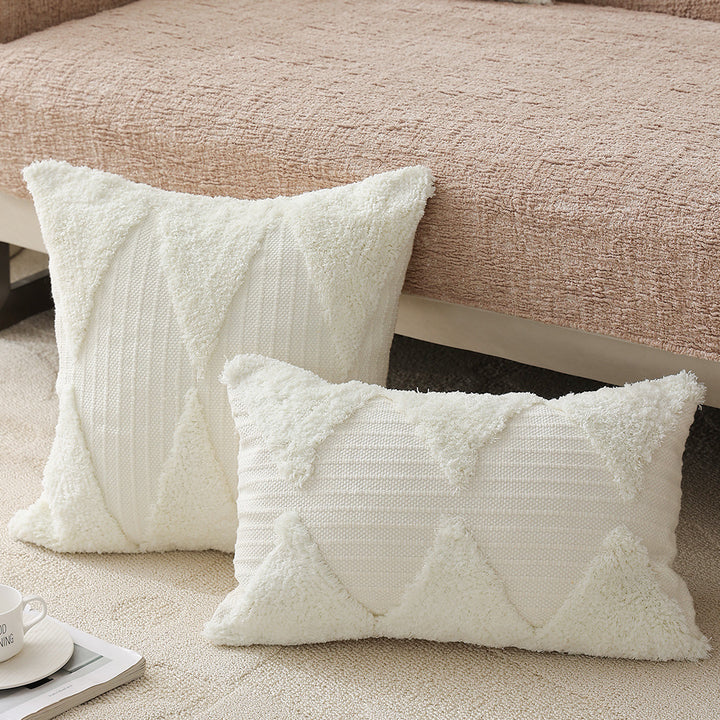 Square decorative pillow with tufted triangle structure and bouclé surface