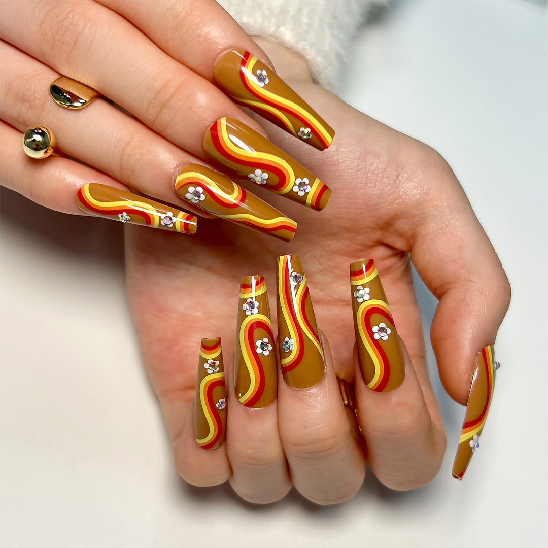 Artful acrylic nails with wave design and floral embellishments Kalsten