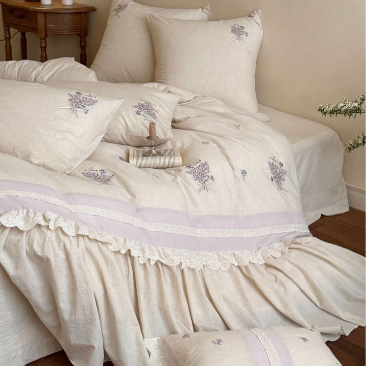 Vintage-inspired bedding set with ruffled bed skirt and delicate floral embroidery