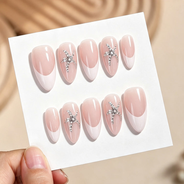 Artificial nail set with delicate pearlescent and glitter accents Kalsten