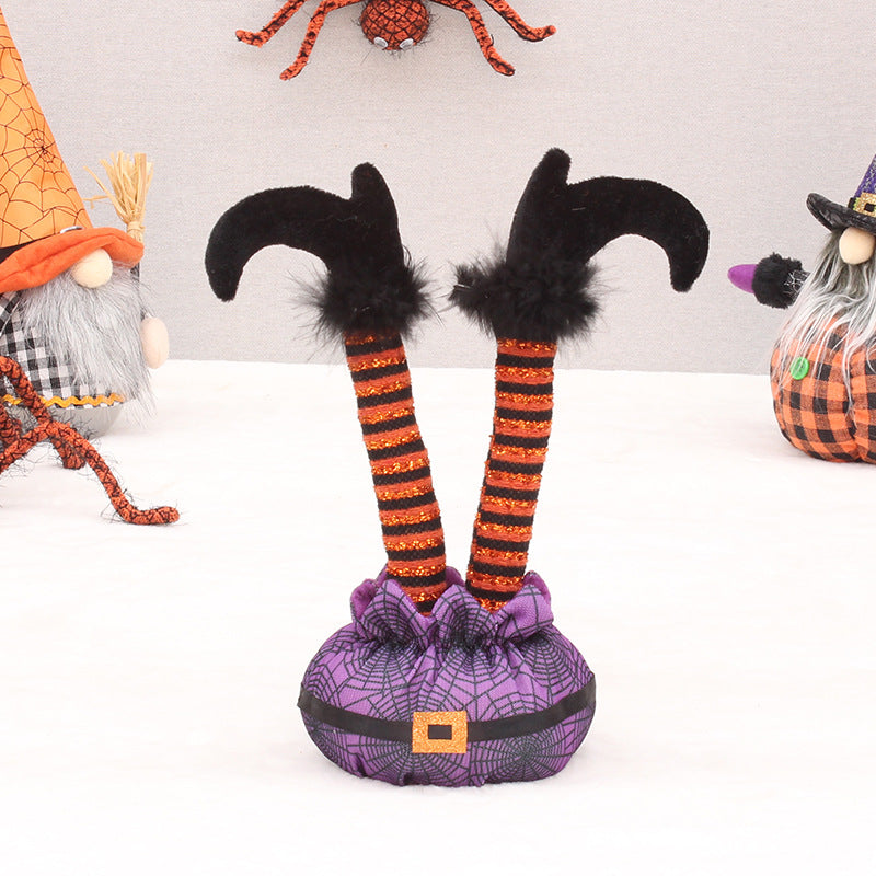 Skurrile Halloween table figure with standing witch legs and spider web sack