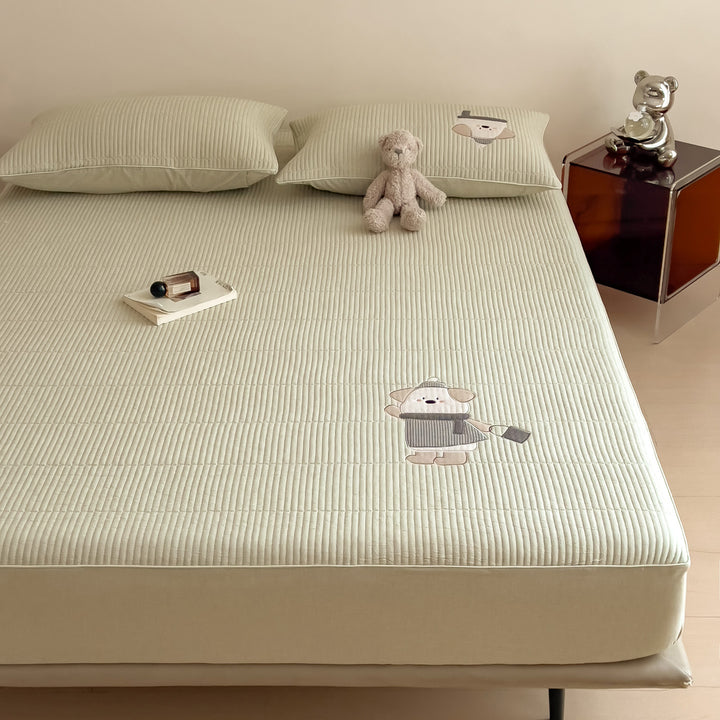 Quilted mattress topper with bunny applique and non-slip bottom