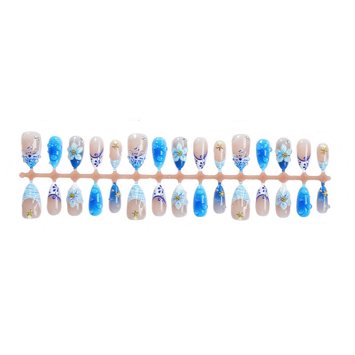 Artificial nail set with maritime designs and floral accents Kalsten