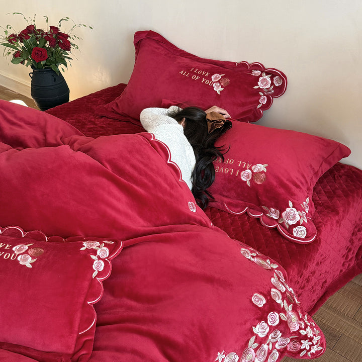Soft-touch bedding set with floral rose embroidery, wavy hem, and reversible pillow.