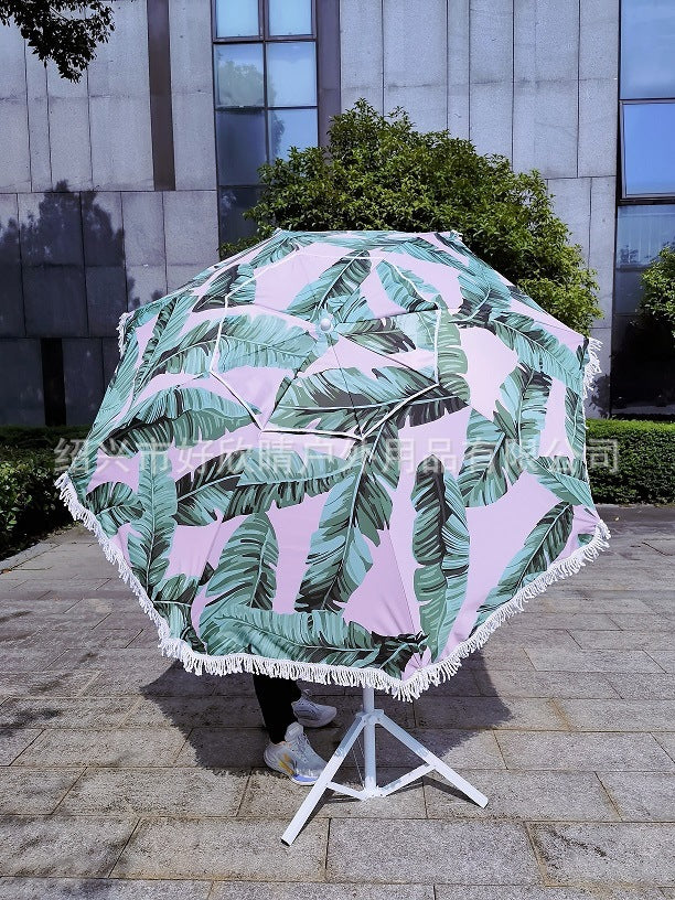 Ladies sun umbrella with tropical leaf design and tassel decoration Kalsten