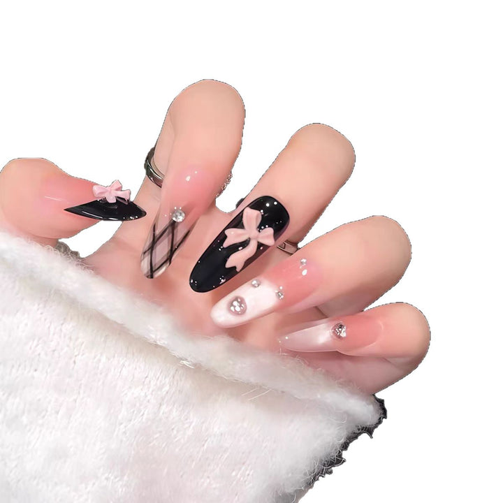 Artificial nails with playful bow and glitter accents Kalsten
