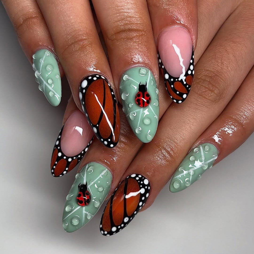 Creative nail art with elaborate butterfly and flower designs Kalsten