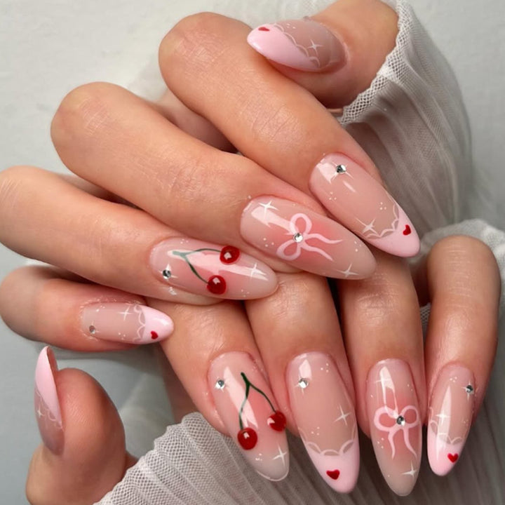 Artifical nails with playful heart and bow designs Kalsten