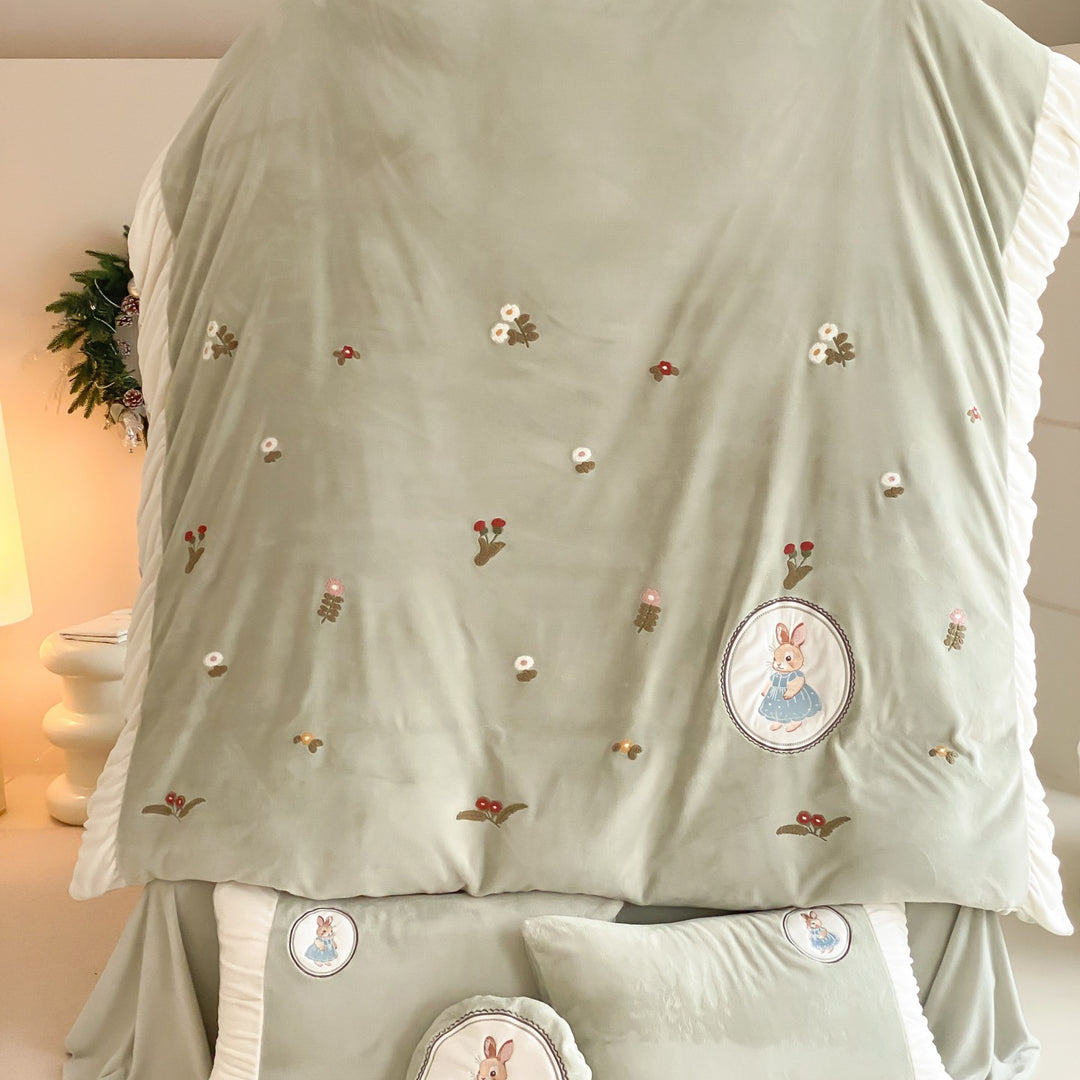 Quilted children's bedding set with embroidered bunny appliqués and ruffles