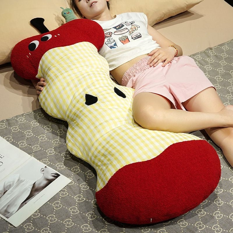 Extra-long ergonomic cuddle body pillow in apple core design with gingham cover and soft plush ends