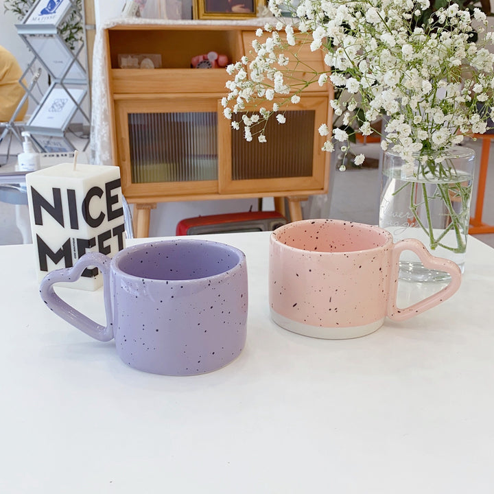 Oversized ceramic mug with heart-shaped handle and dotted glaze