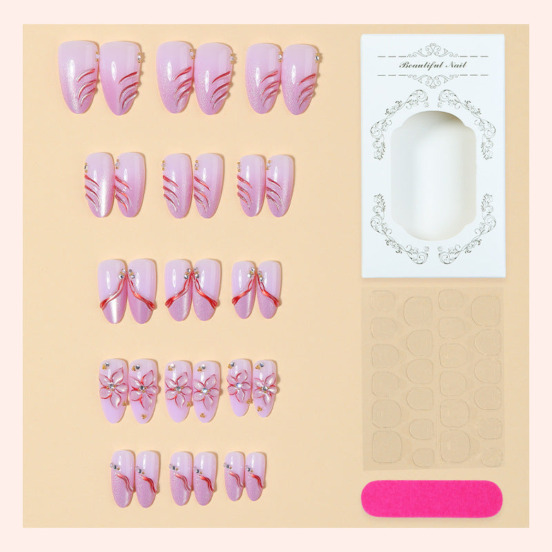 Artificial nail set with delicate floral designs and elegant glitter details Kalsten