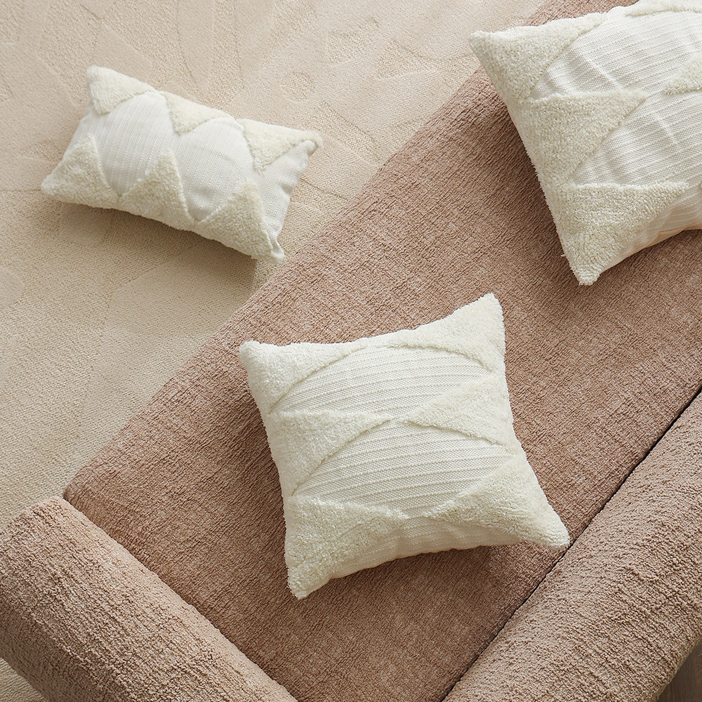 Square decorative pillow with tufted triangle structure and bouclé surface