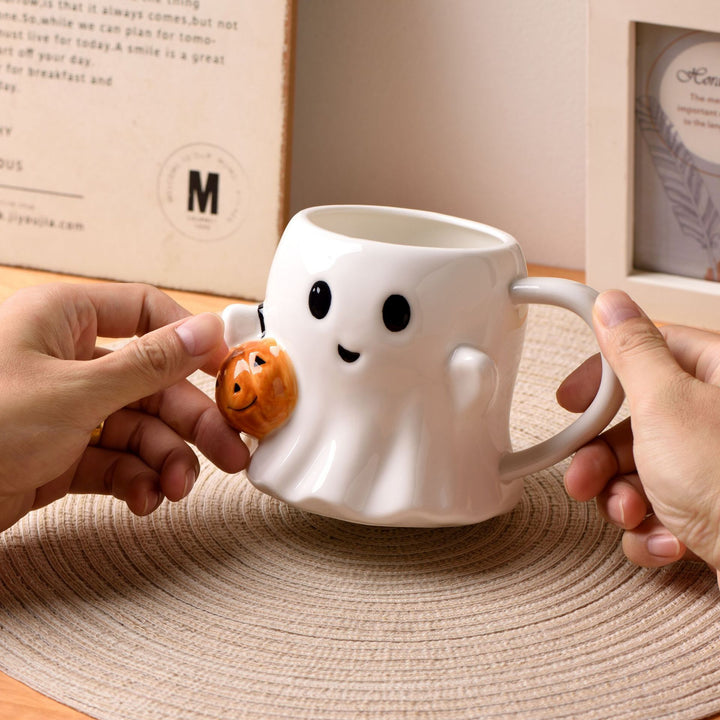 Ceramic mug with 3D ghost shape and pumpkin appliqué