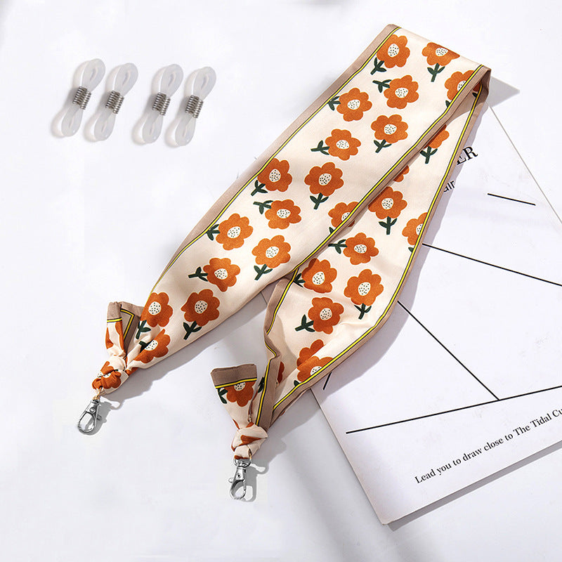 Fashionable fabric mask holder with floral motifs Kalsten