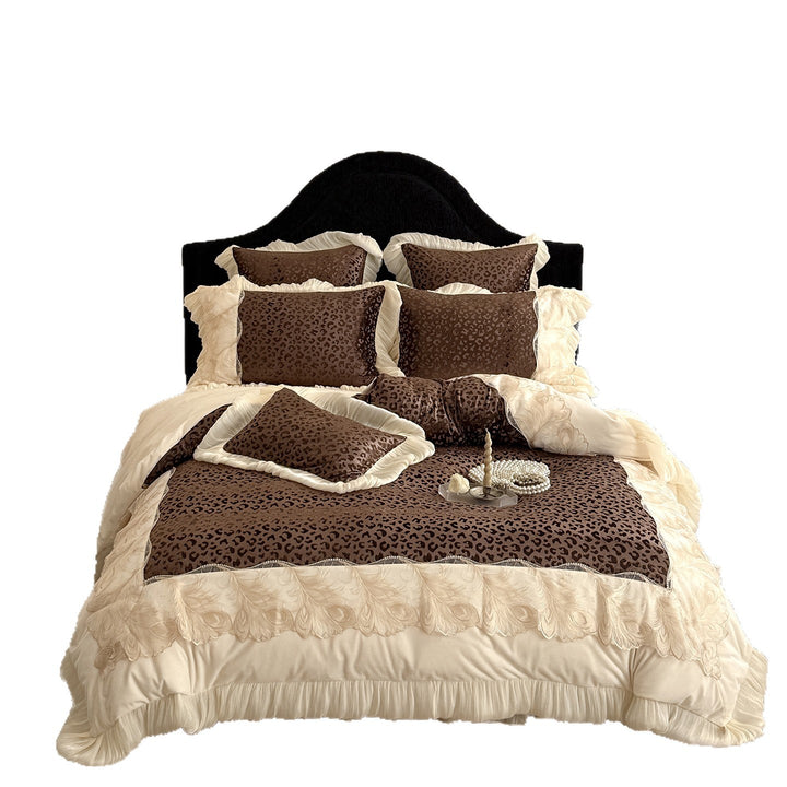 Opulent quilted bedding set with leopard pattern, ruffle trim and decorative embroidery