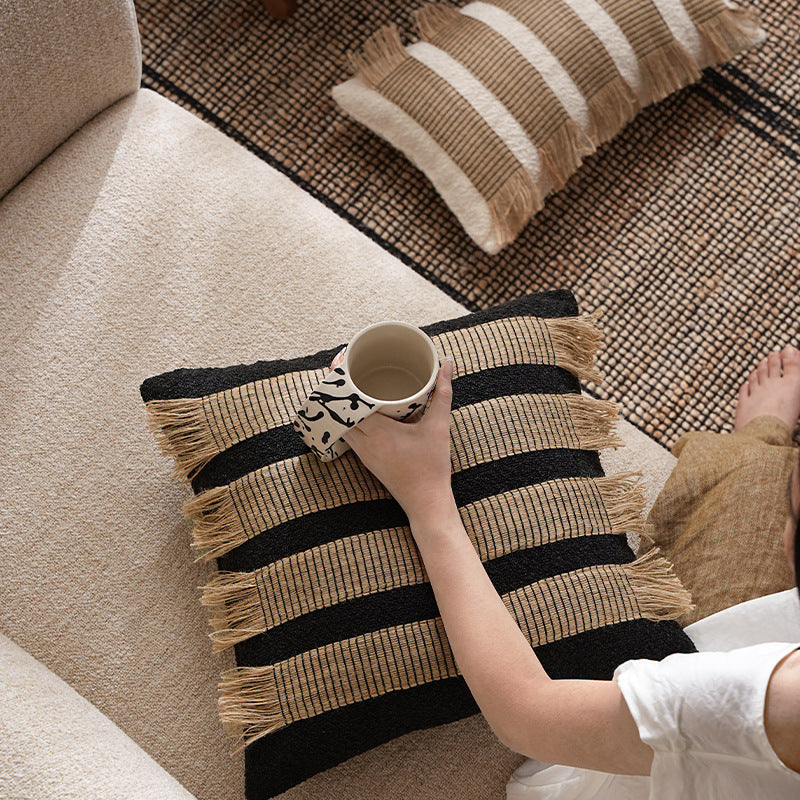 Rectangular decorative cushion with fringes and woven stripes