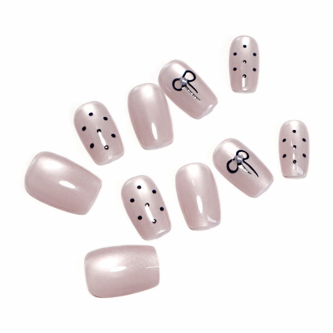 Artificial nail extensions with decorative bows and dots Kalsten