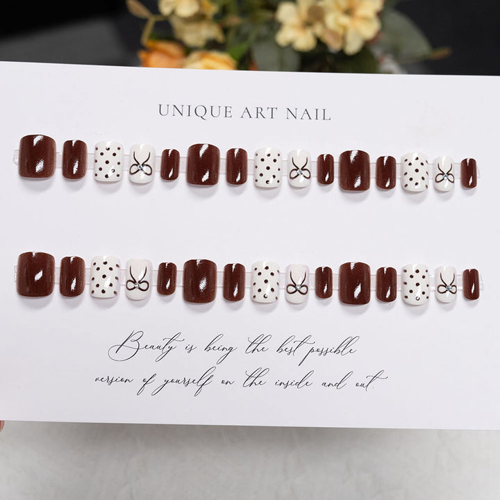 Decorative Press-On Nail Design with Bow and Polka Dots