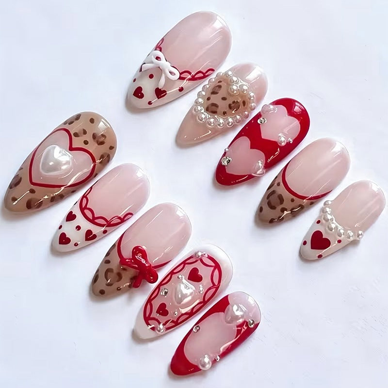 Artificial nail set with romantic heart designs and glamorous 3D details Kalsten