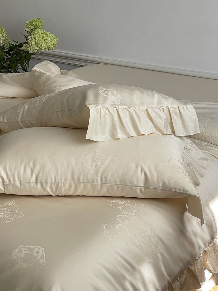 Bedding set made of cotton satin with ruffle, subtle jacquard floral relief and silky-matt finish