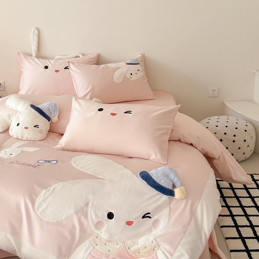 Children's bedding set with three-dimensional ears, plush pillow, and embroidered rabbit appliqués