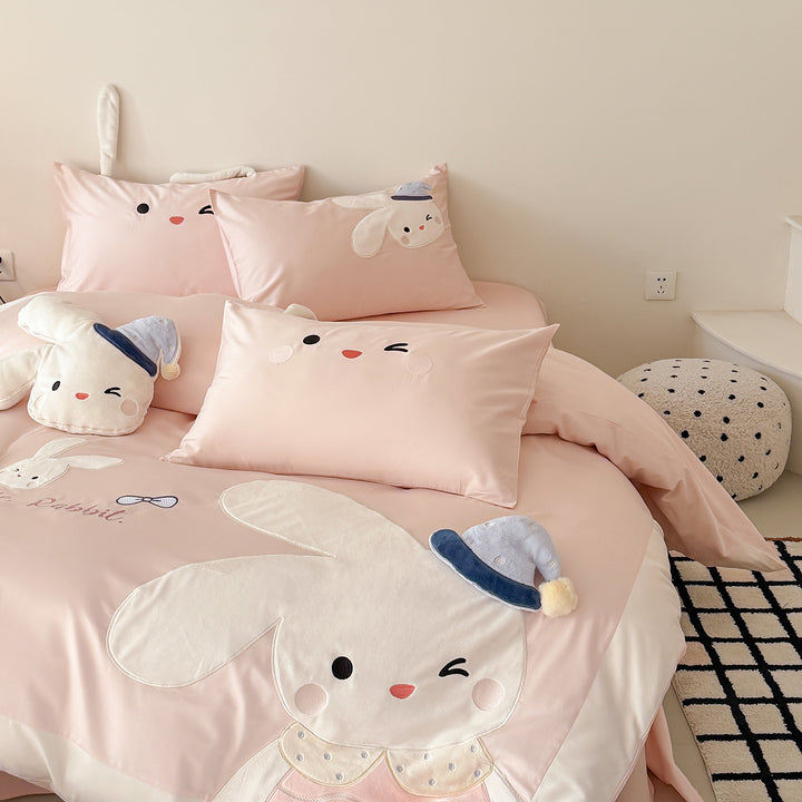 Children's bedding set with three-dimensional ears, plush pillow, and embroidered rabbit appliqués