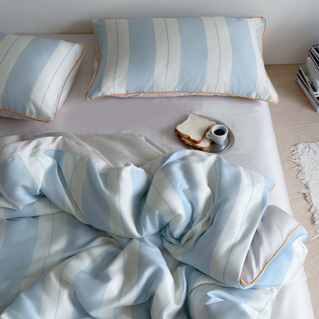 Luxurious cotton satin bedding set with fine striped pattern and piping