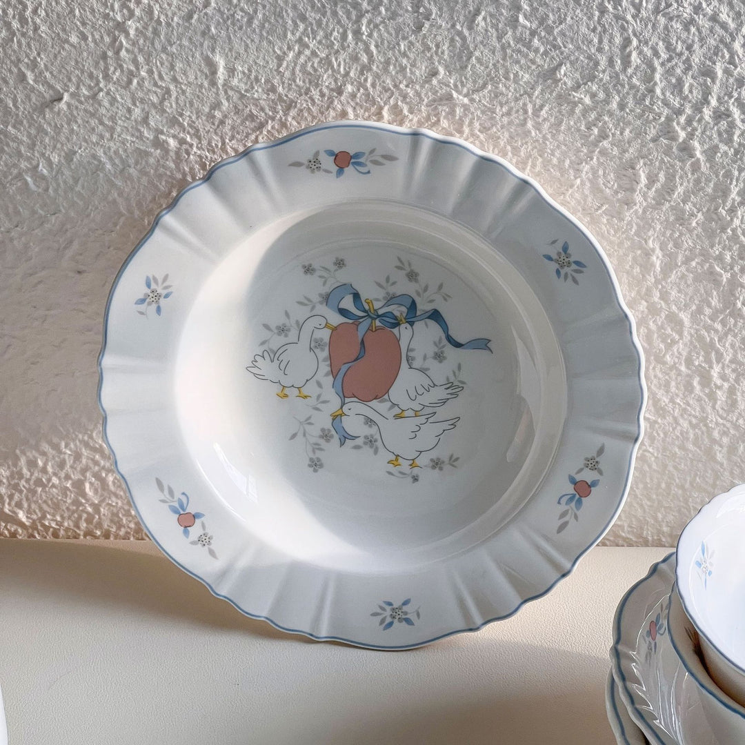 Decorative porcelain soup plate with ribbed edge and duck motif